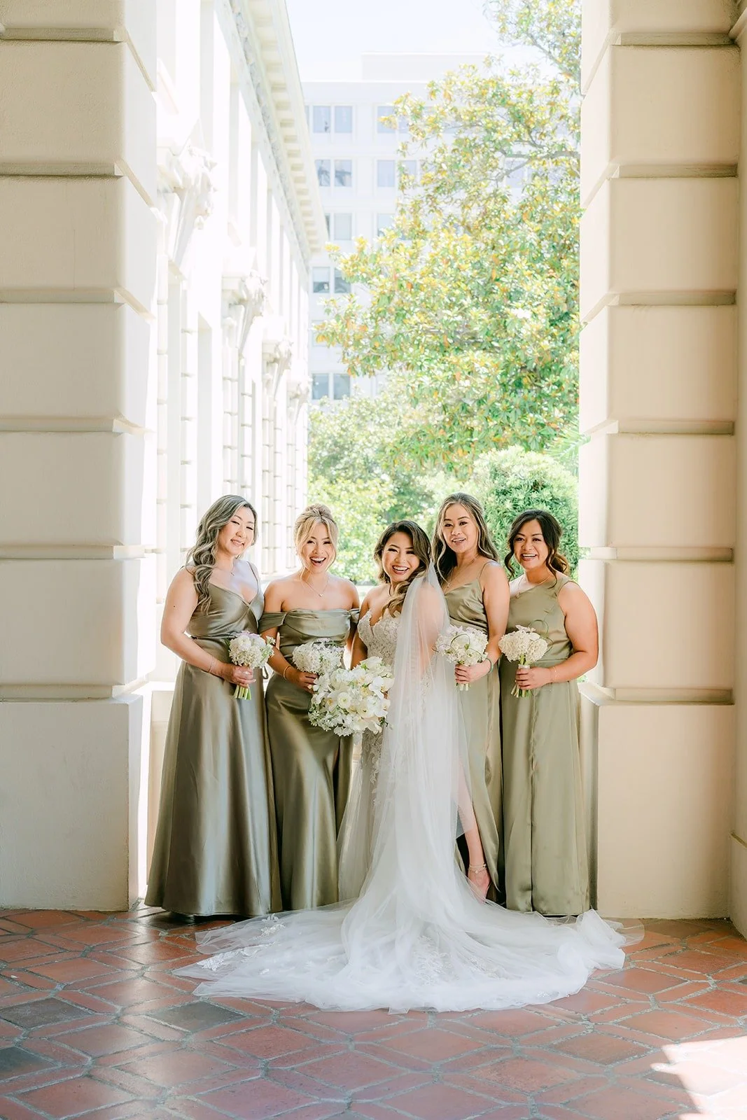 Candice with her bridesmaids in sage green at Pasadena City Hall
