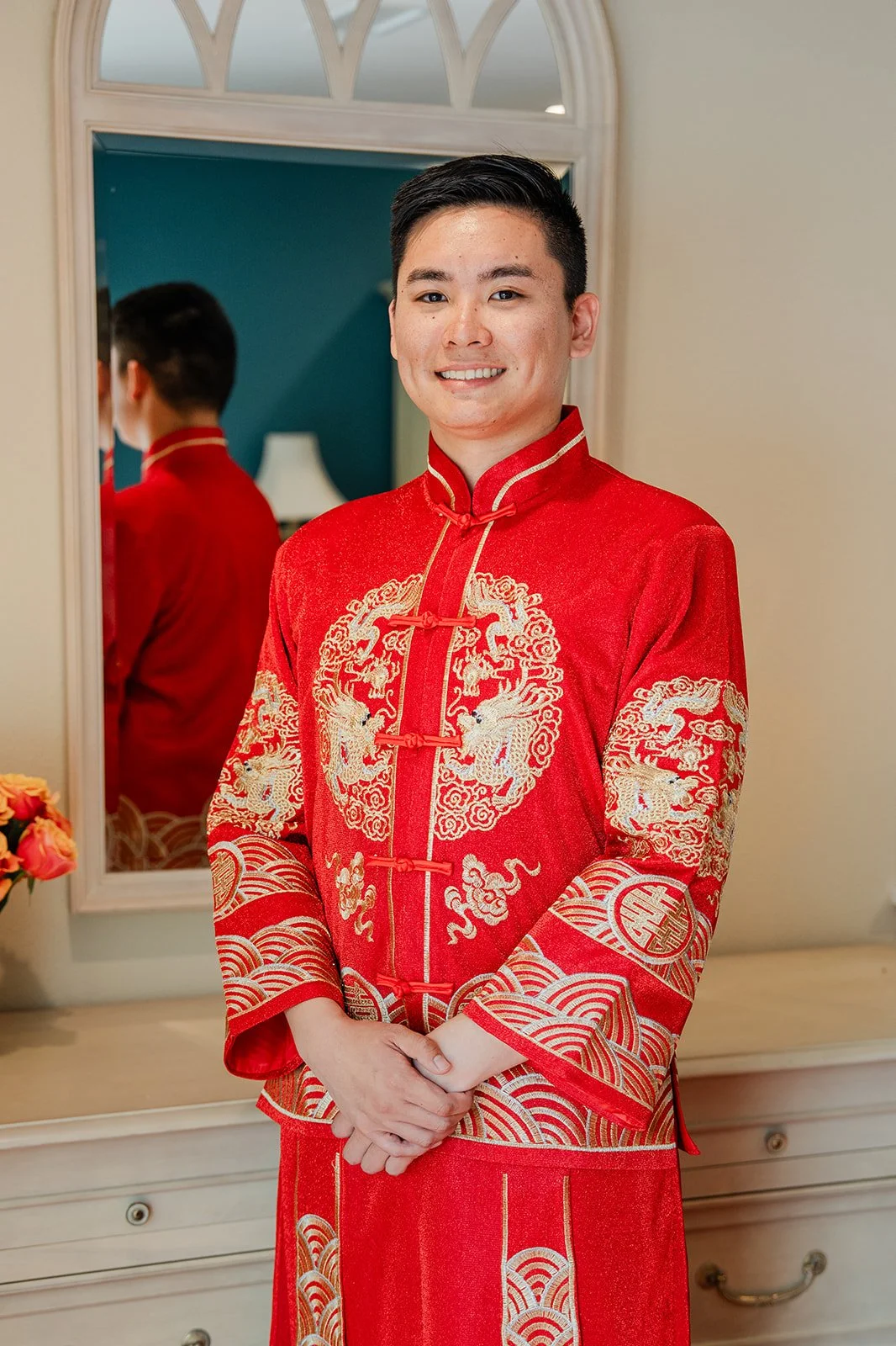 Henrik smiling in his changshan by the mirror.