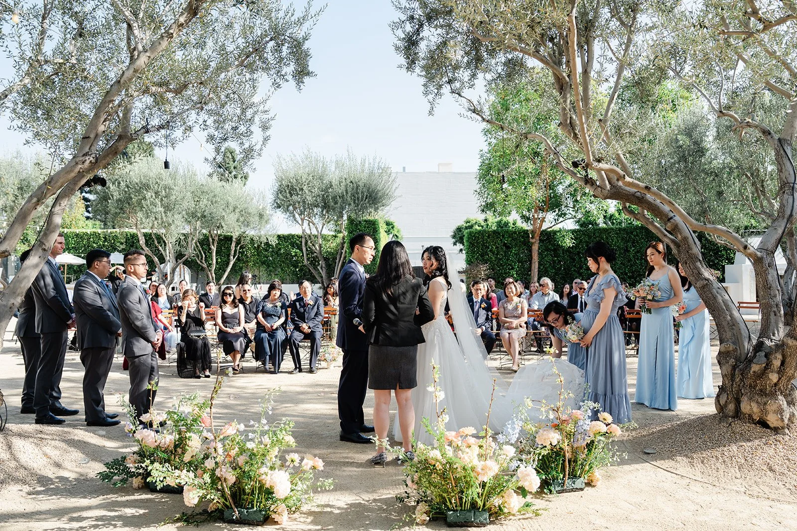 Wide view of the Olive Grove ceremony with guests and the wedding party