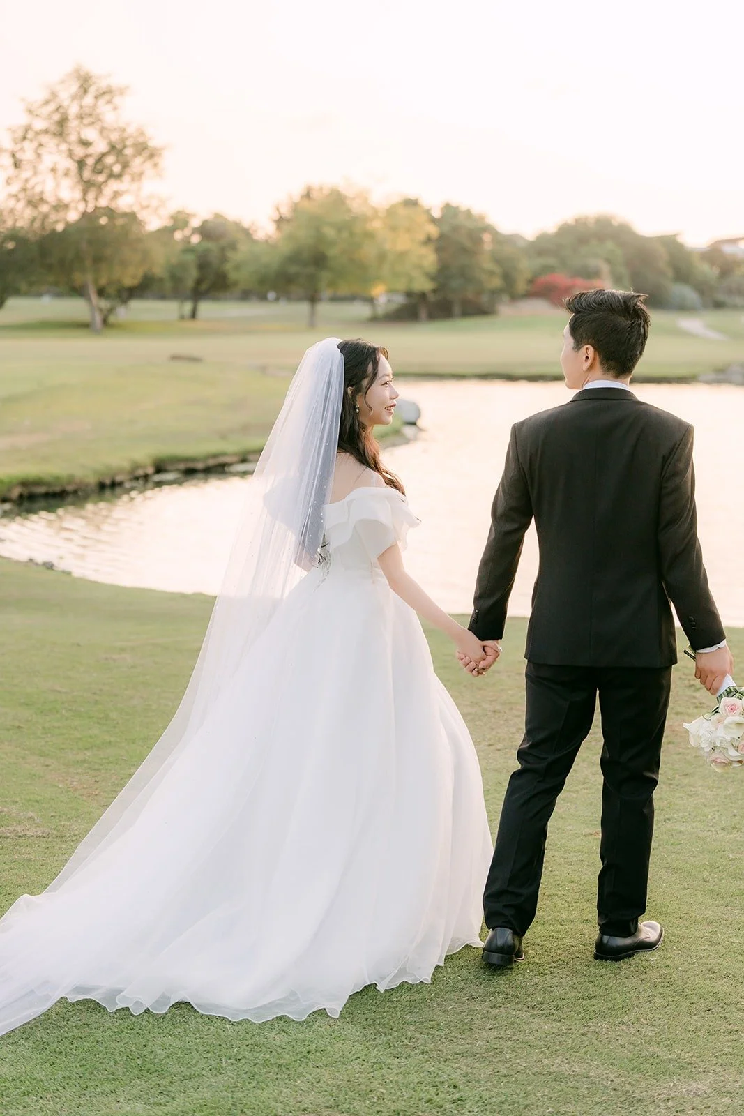 Jeannie and Eunsang walking hand in hand along the water