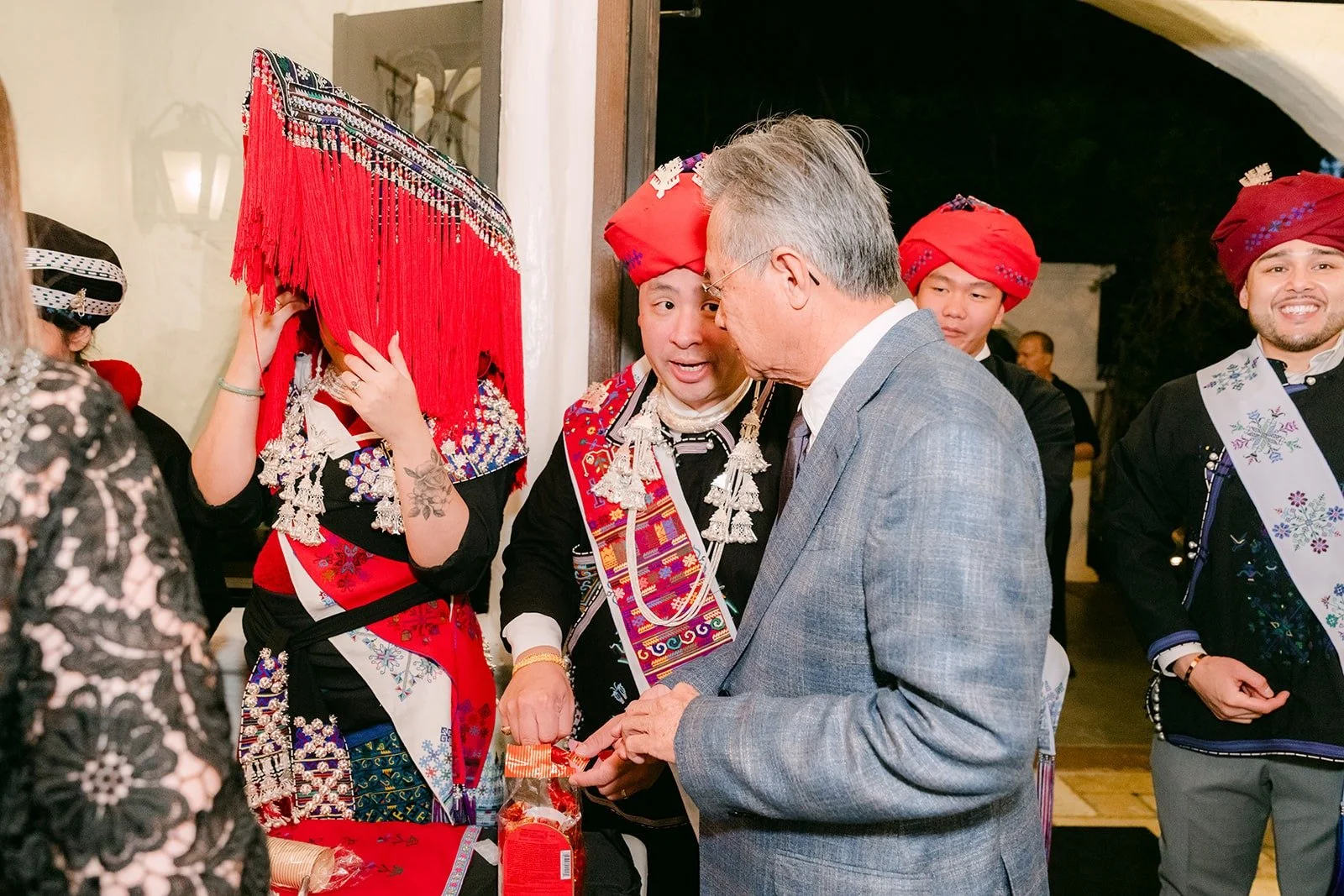 Family in embroidered Mien dress and red turbans