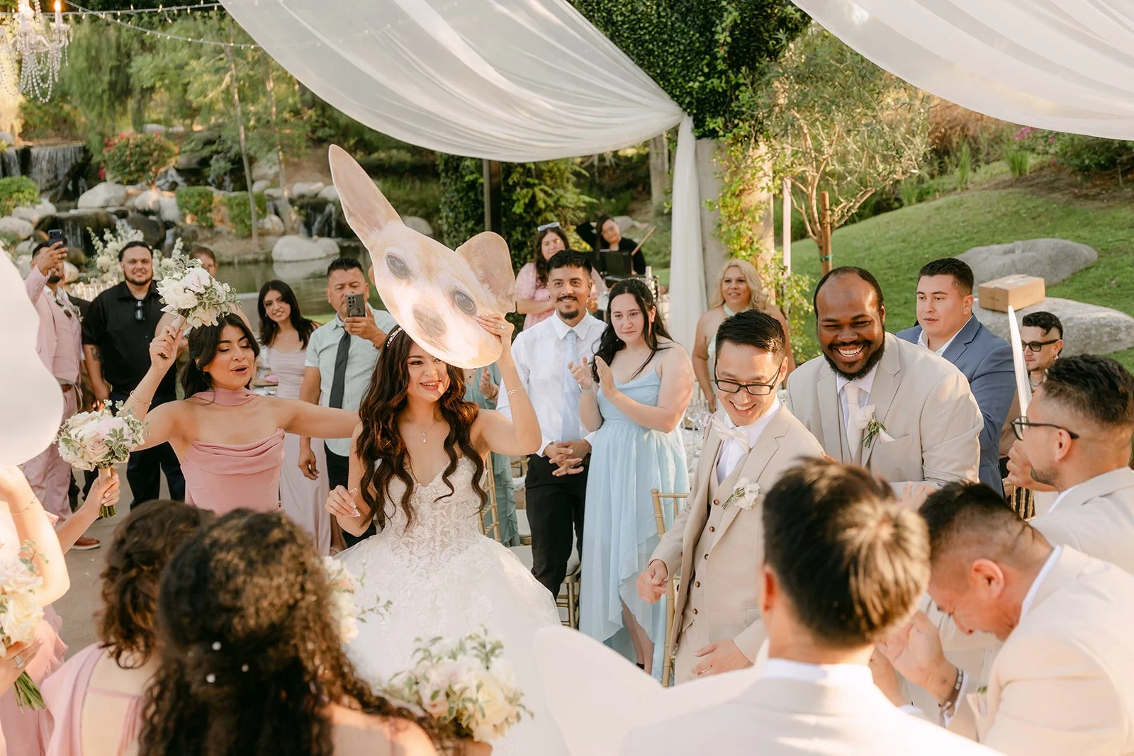 Guests cheering as Sandra and Kevin make their grand entrance.