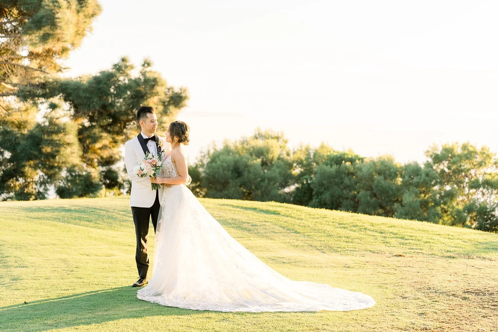 Josephine and David on a grassy rise overlooking the course