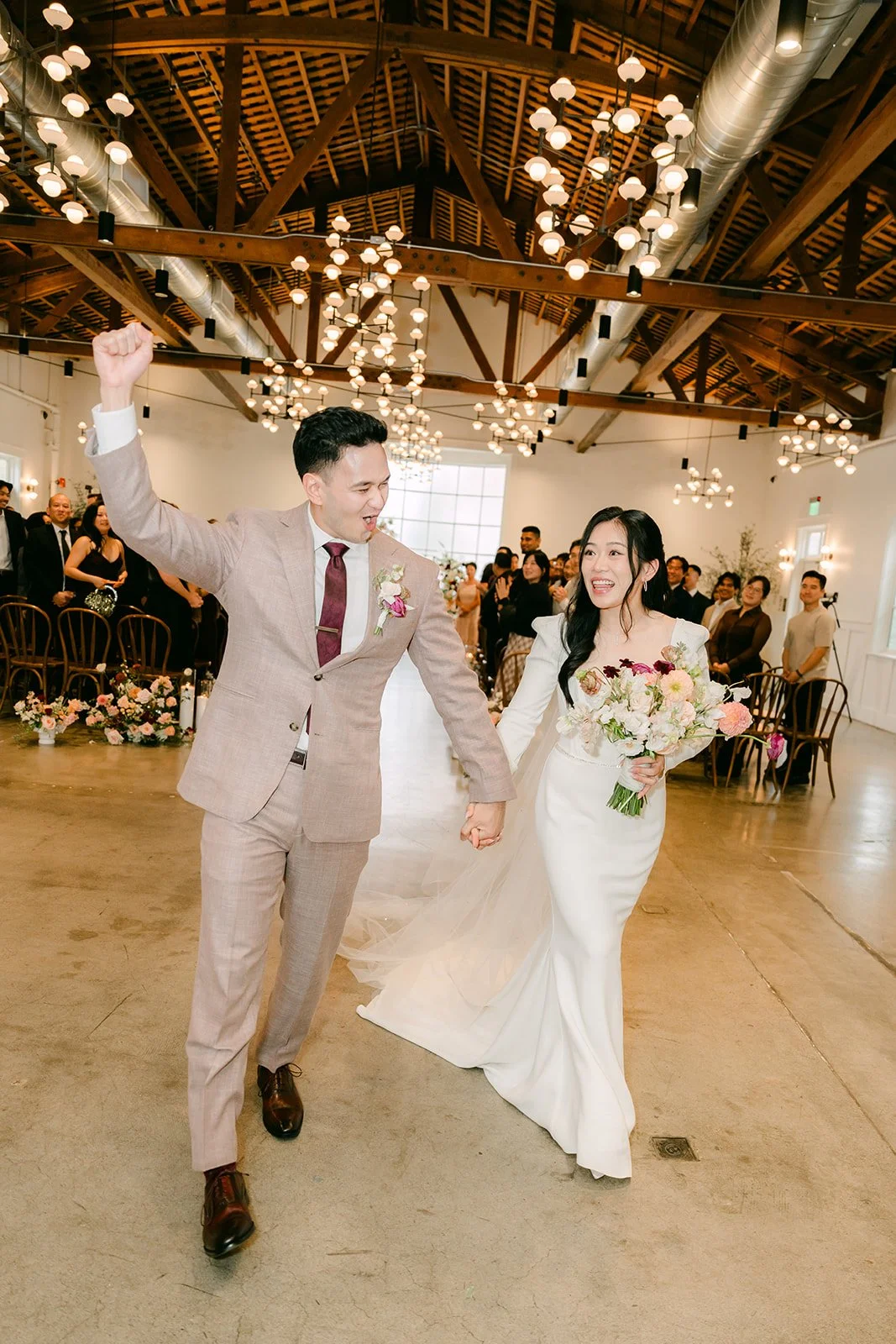 Michael pumping his fist as he and Denise head up the aisle.