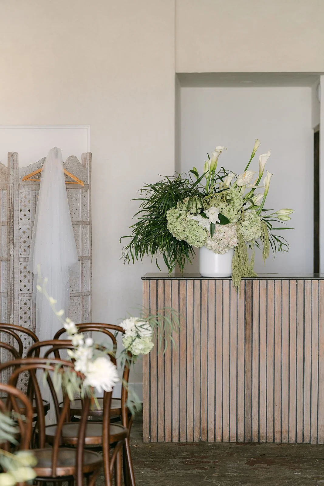A white floral arrangement on the bar