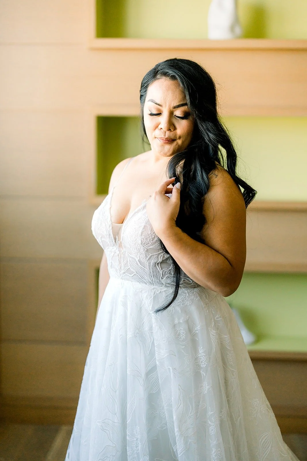 Betsy in her strapless lace gown by the window