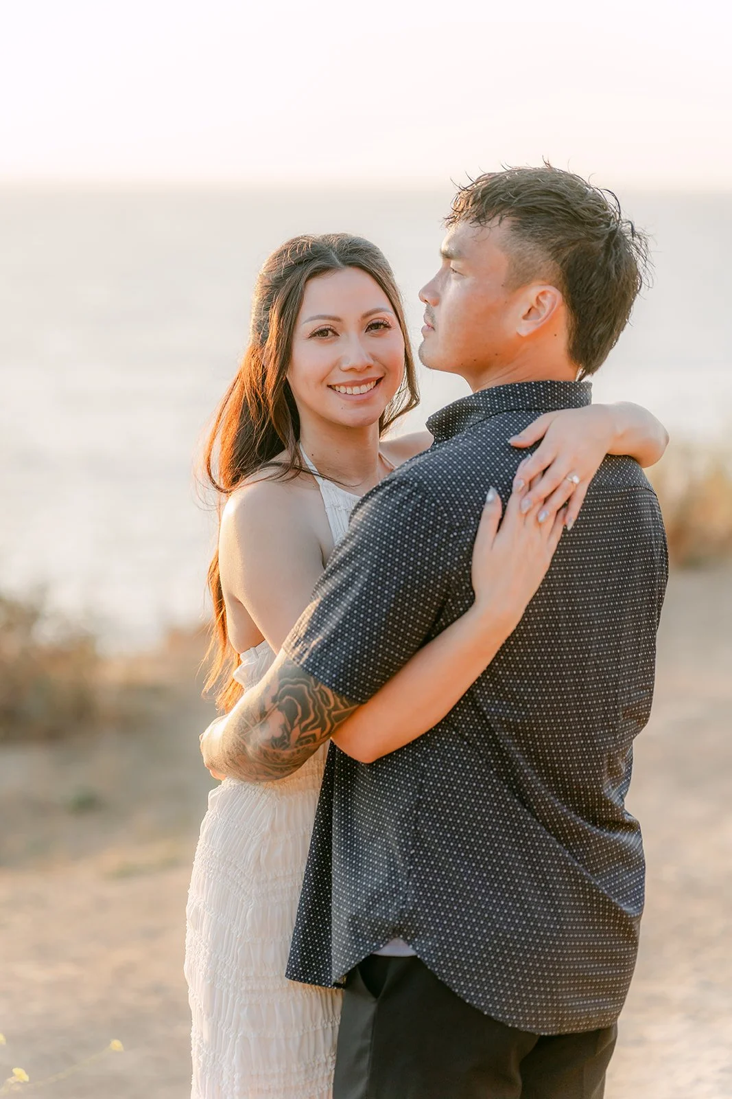 Victoria wraps her arms around Andrew in the late afternoon sun.
