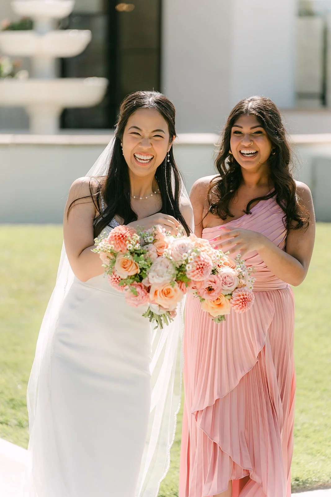 Stephanie sharing a big smile with one of her bridesmaids