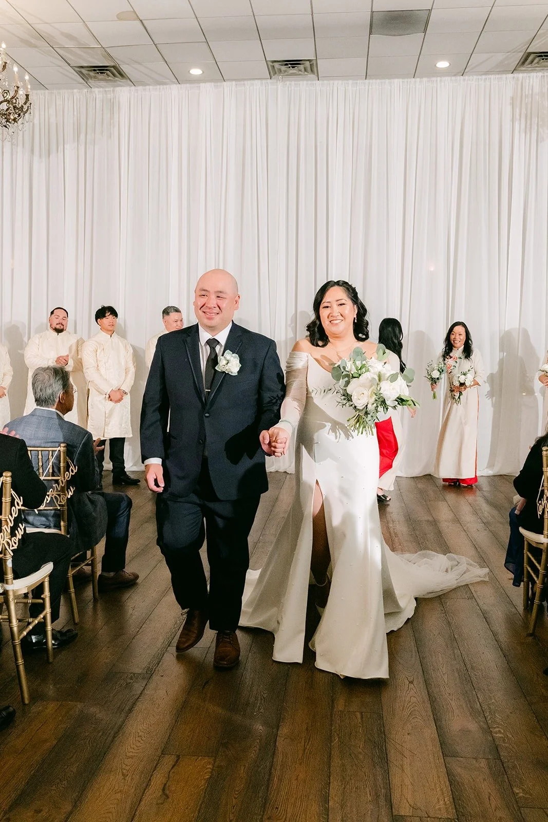 Vivian and Yao walking back up the aisle as husband and wife, photographed by One and Only Production