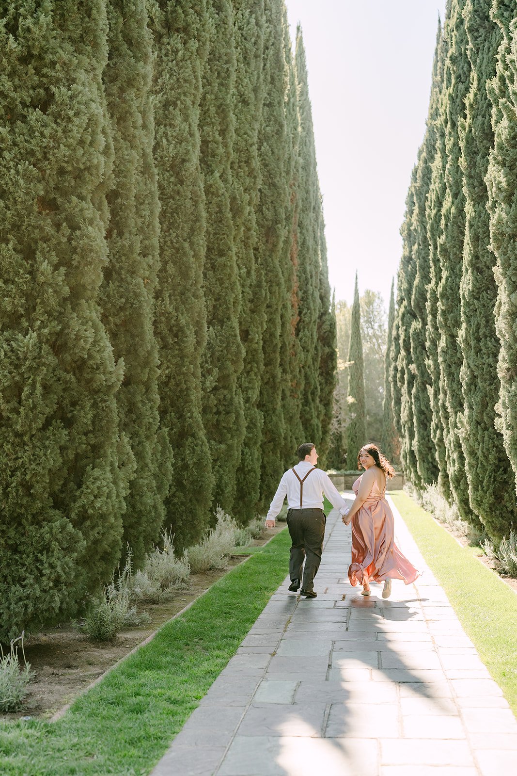 Saira and Matthew at the end of the tall cypress walkway.