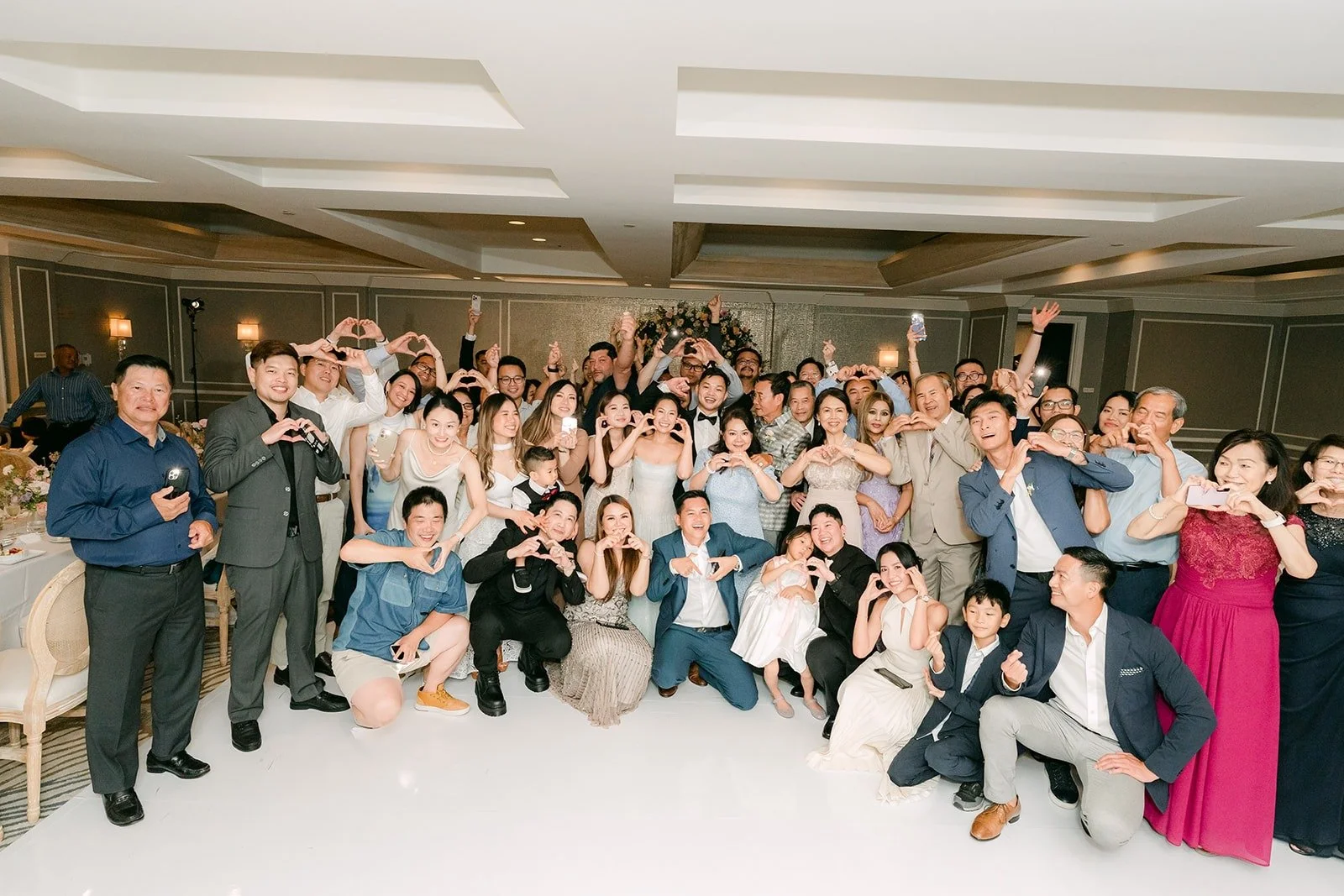 A group photo of everyone on the dance floor in the ballroom