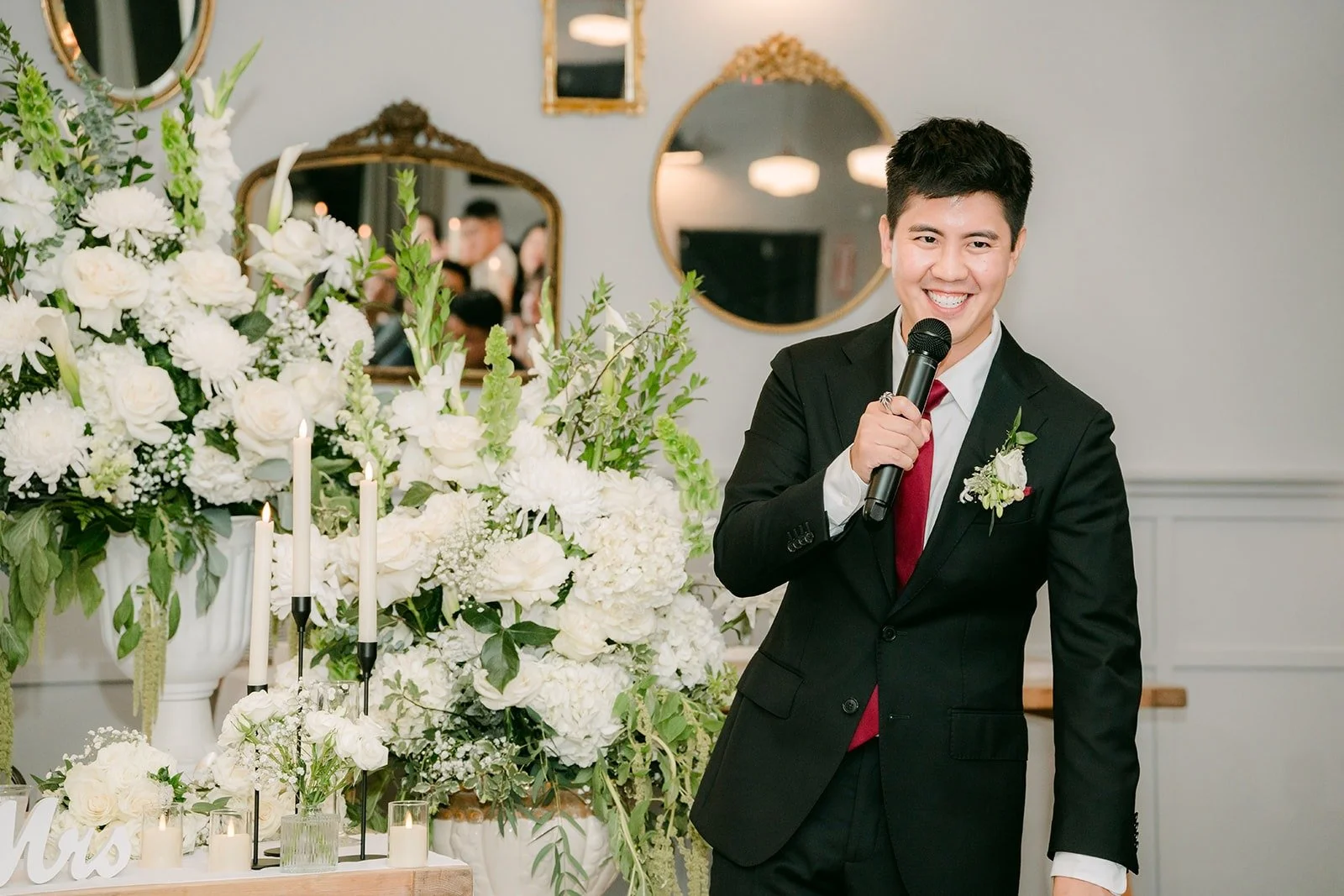 A groomsman giving a toast with the microphone