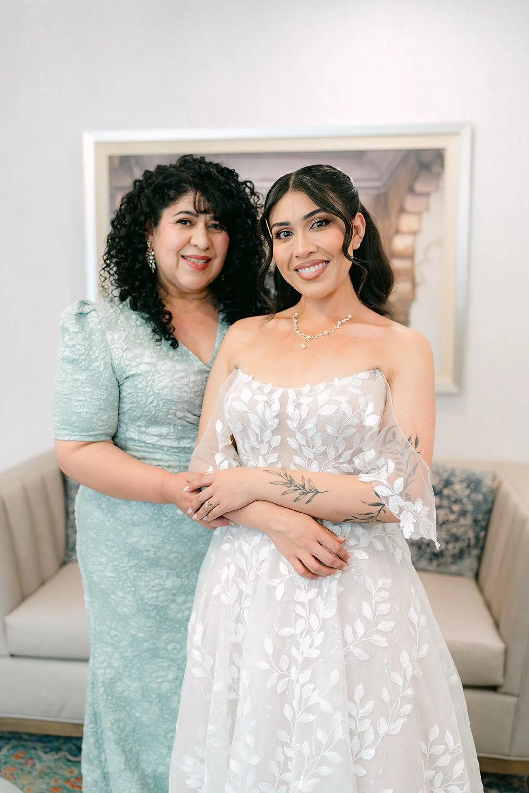 Fernanda posing with a loved one in sage, photographed by One and Only Production.