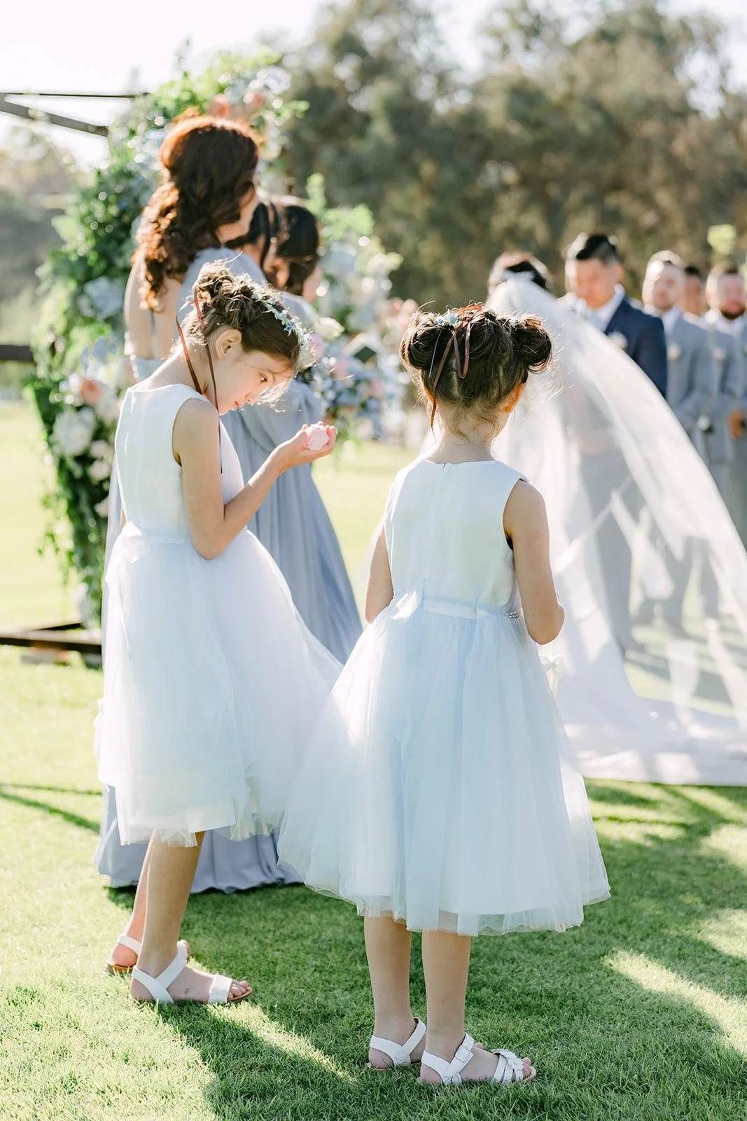 Flower girls and bridesmaids watching the ceremony