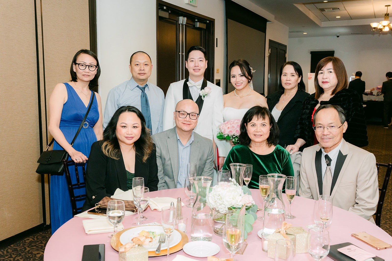 A full table of guests posing during table rounds