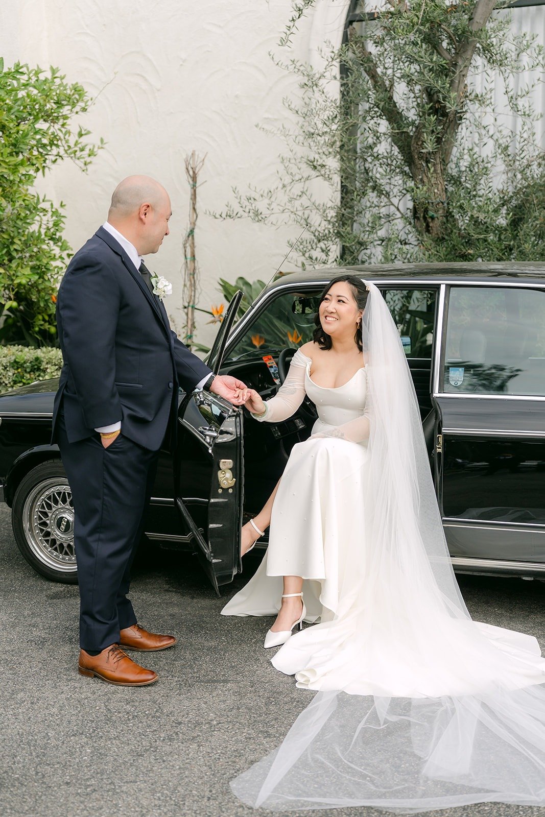 Yao helping Vivian out of the vintage black car