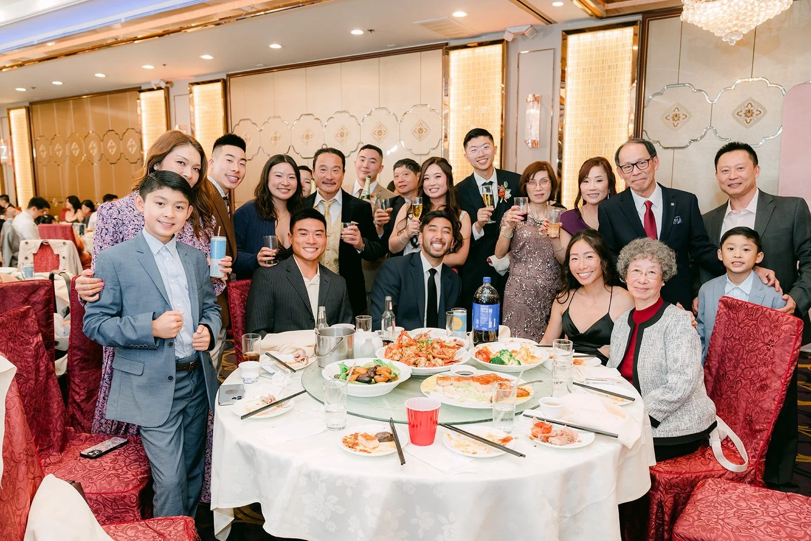 A full table of guests gathered for a photo, photographed by One and Only Production