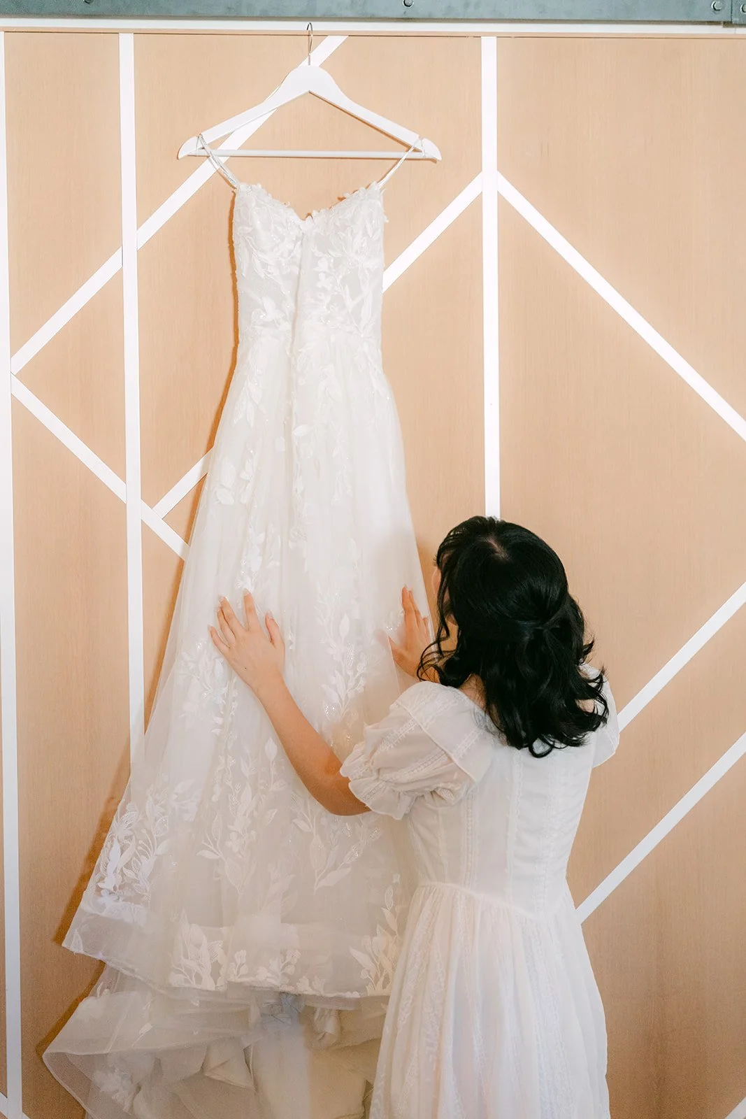 Vivian looking up at her gown on the barn door