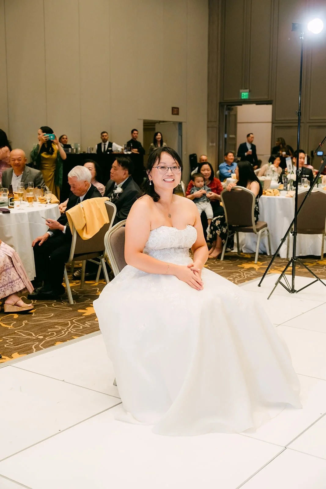 Stella seated in the middle of the dance floor, waiting for a surprise