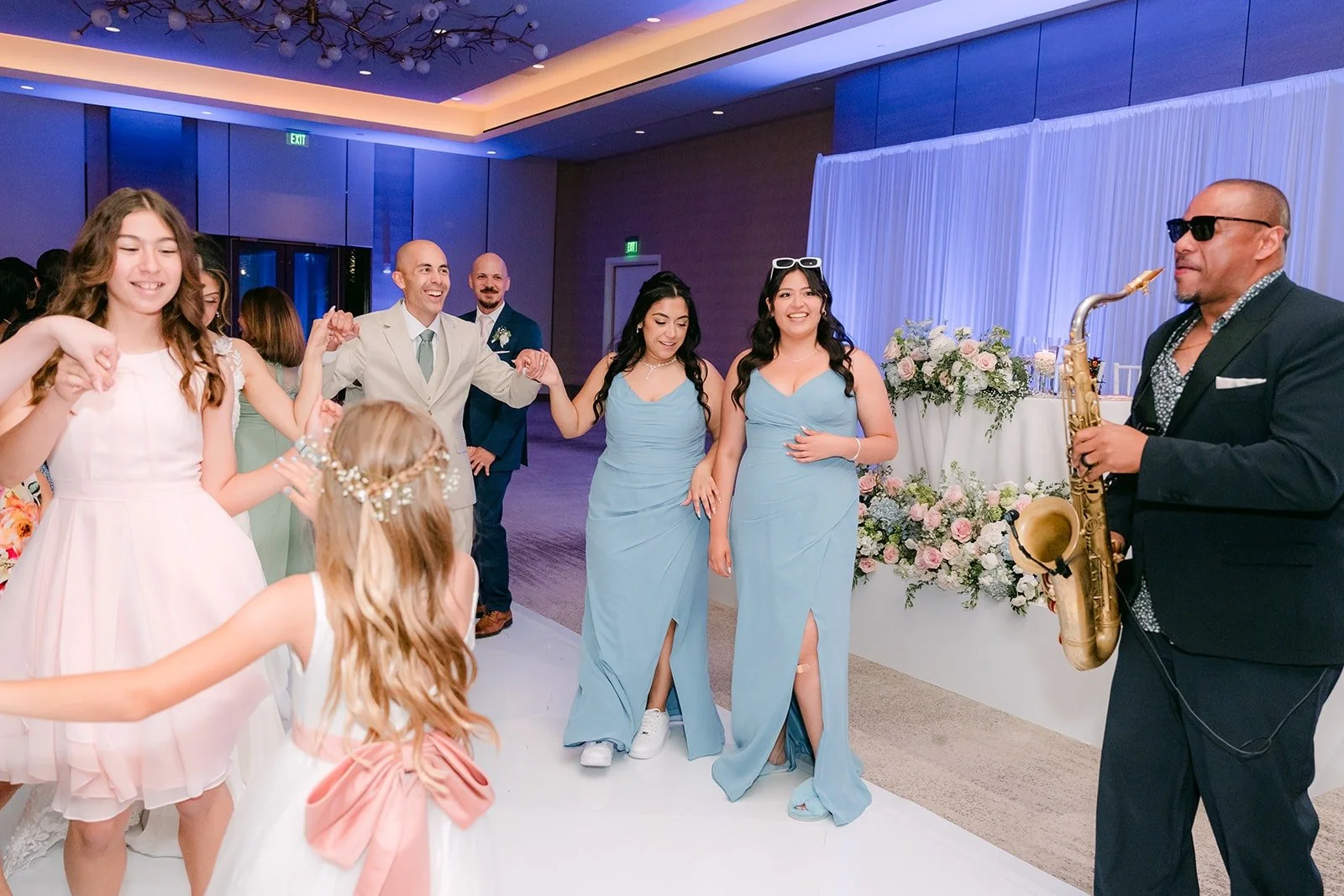 The saxophone player joins the party on the dance floor