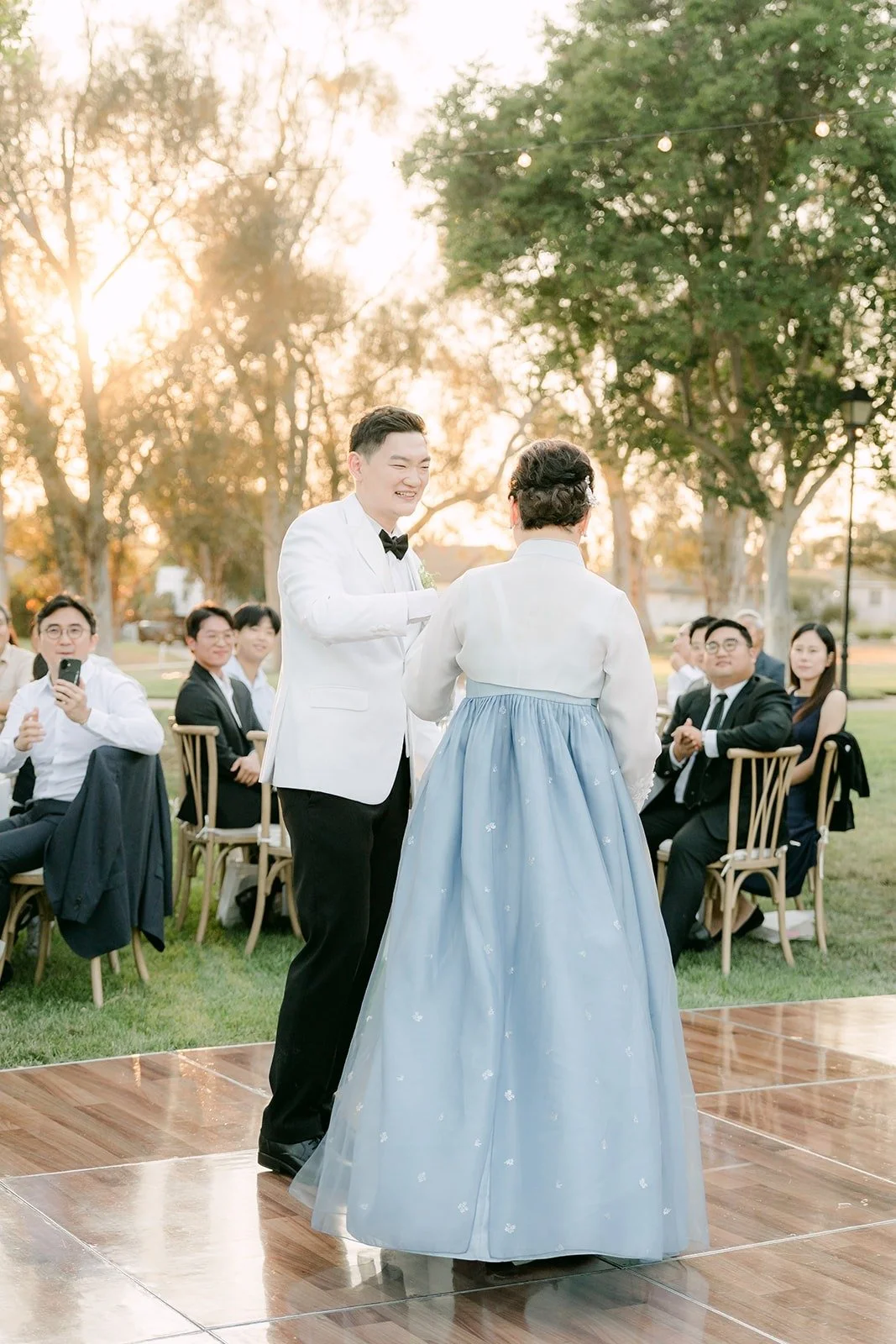Sam and his mom sharing a dance as guests watch, photographed by One and Only Production