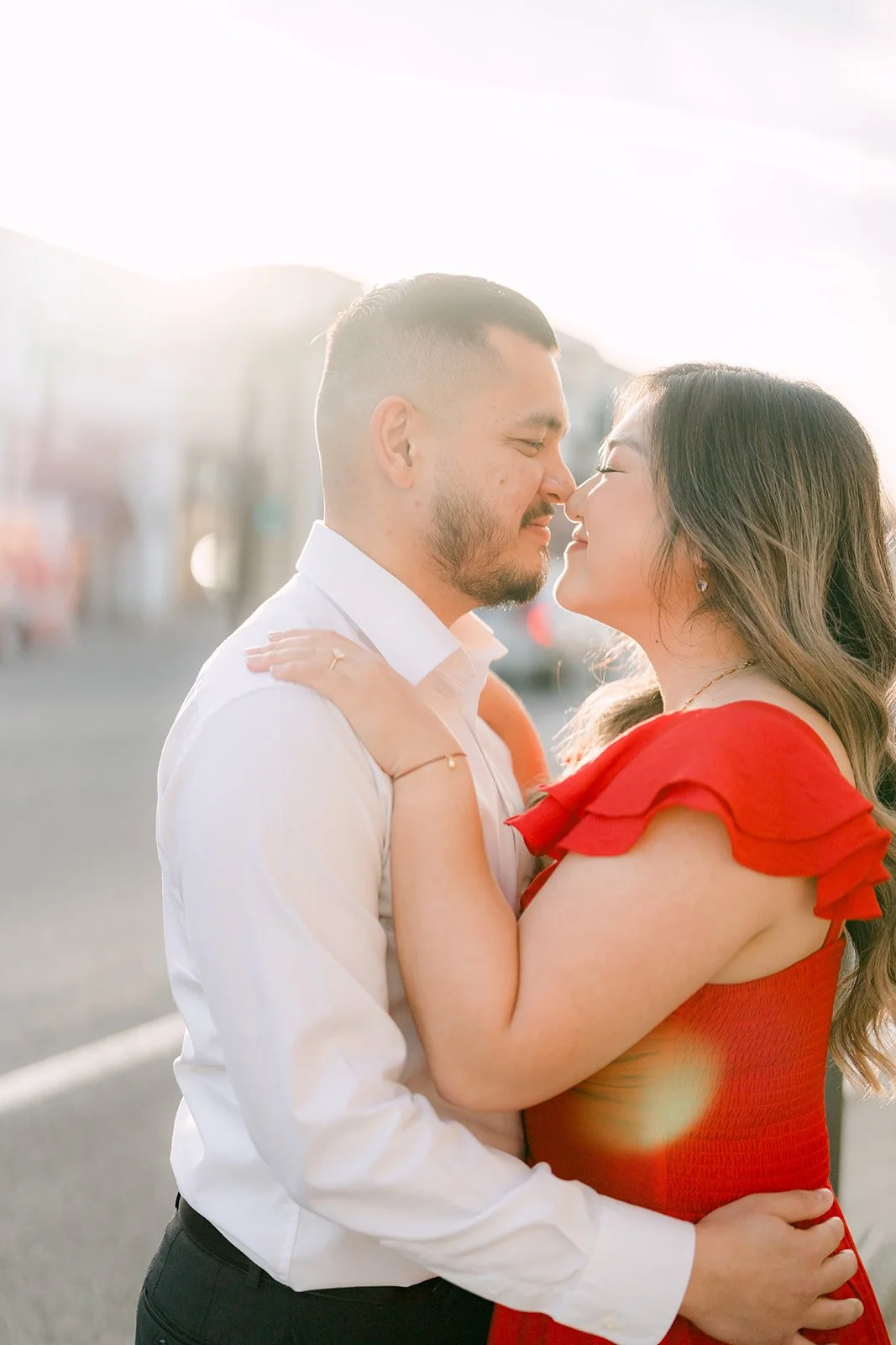 Linh and Ankush nose to nose in warm afternoon light.