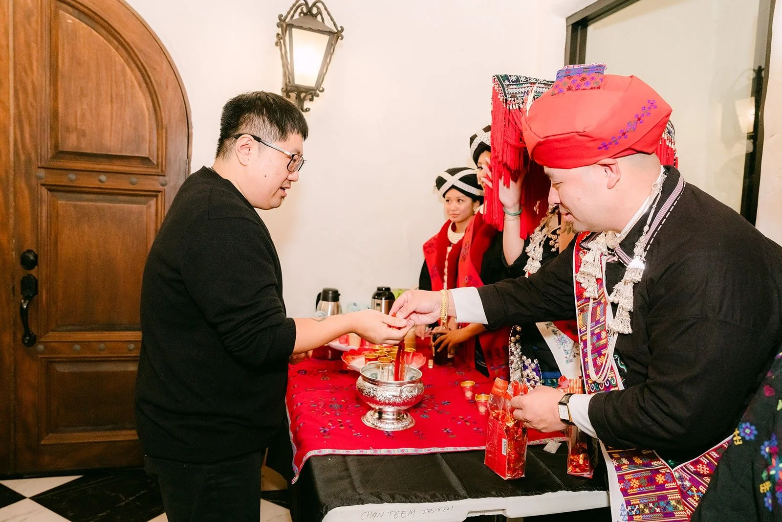 Yao's family greeting guests in traditional Mien clothing