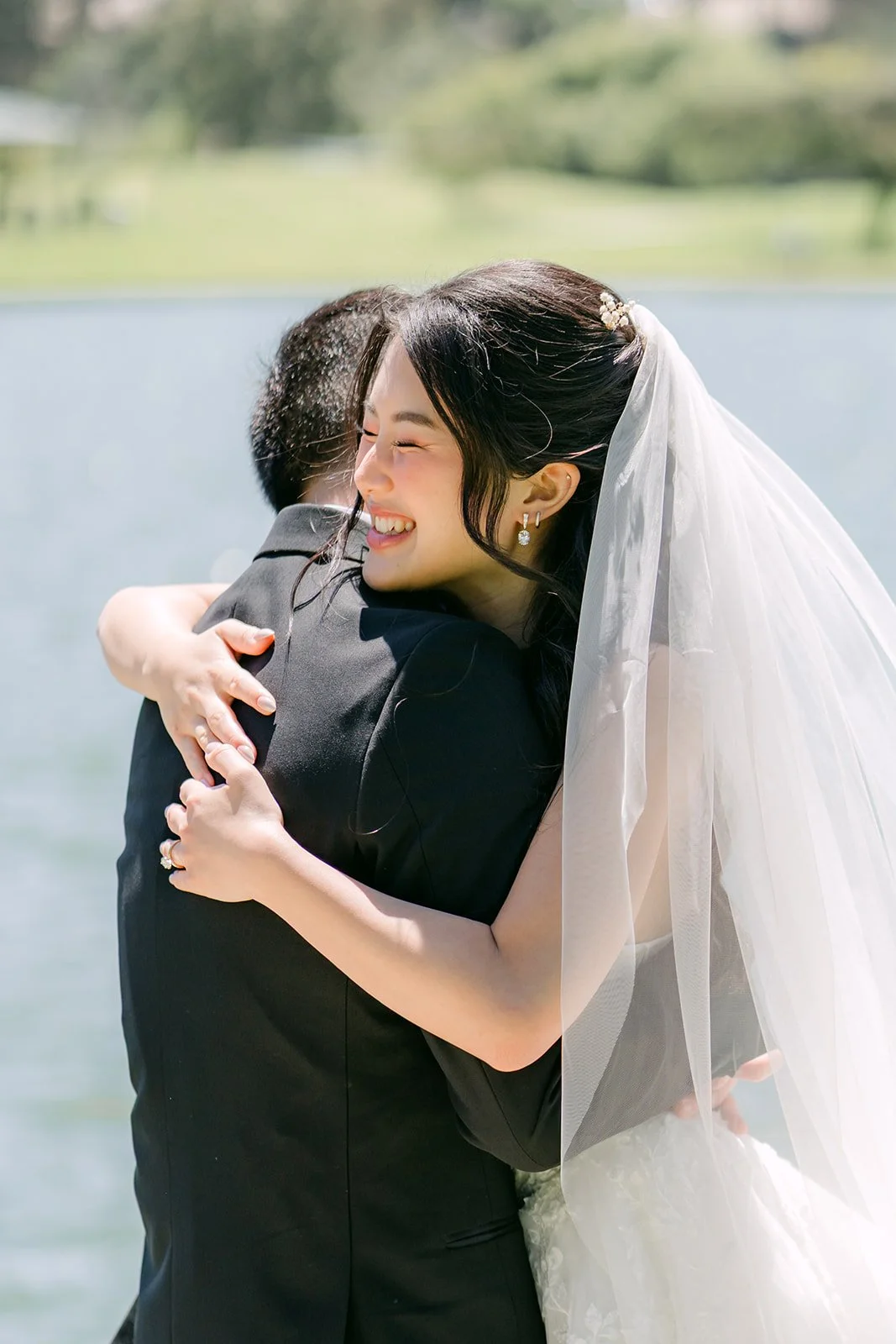 Clarissa and Austin hugging by the lake