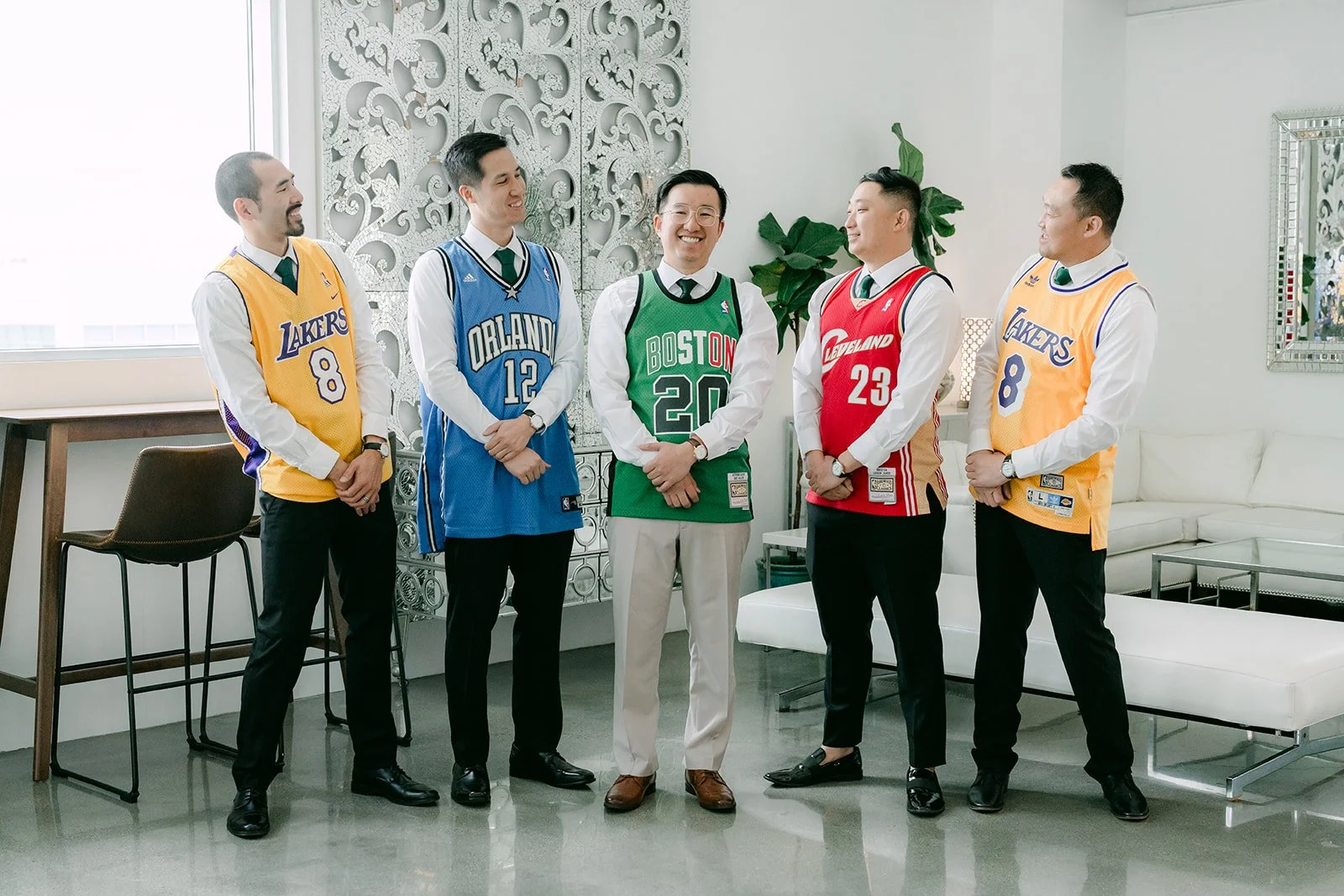 Groom and groomsmen in basketball jerseys before getting dressed