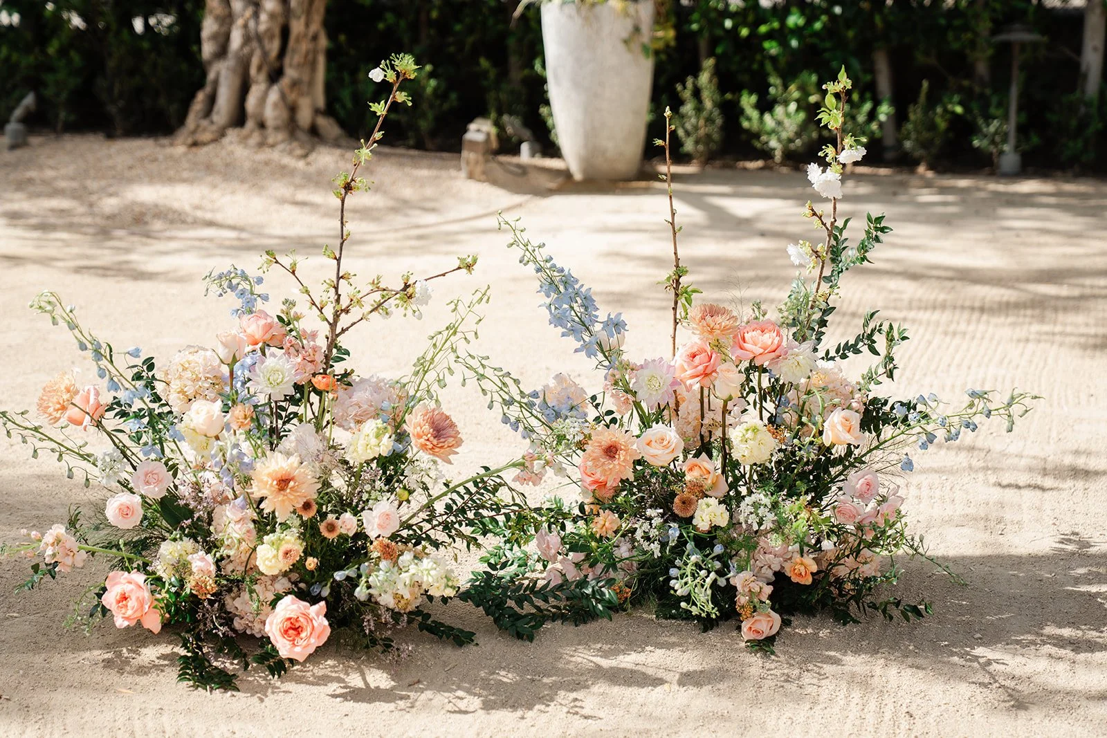 Pastel floral arrangements framing the ceremony space