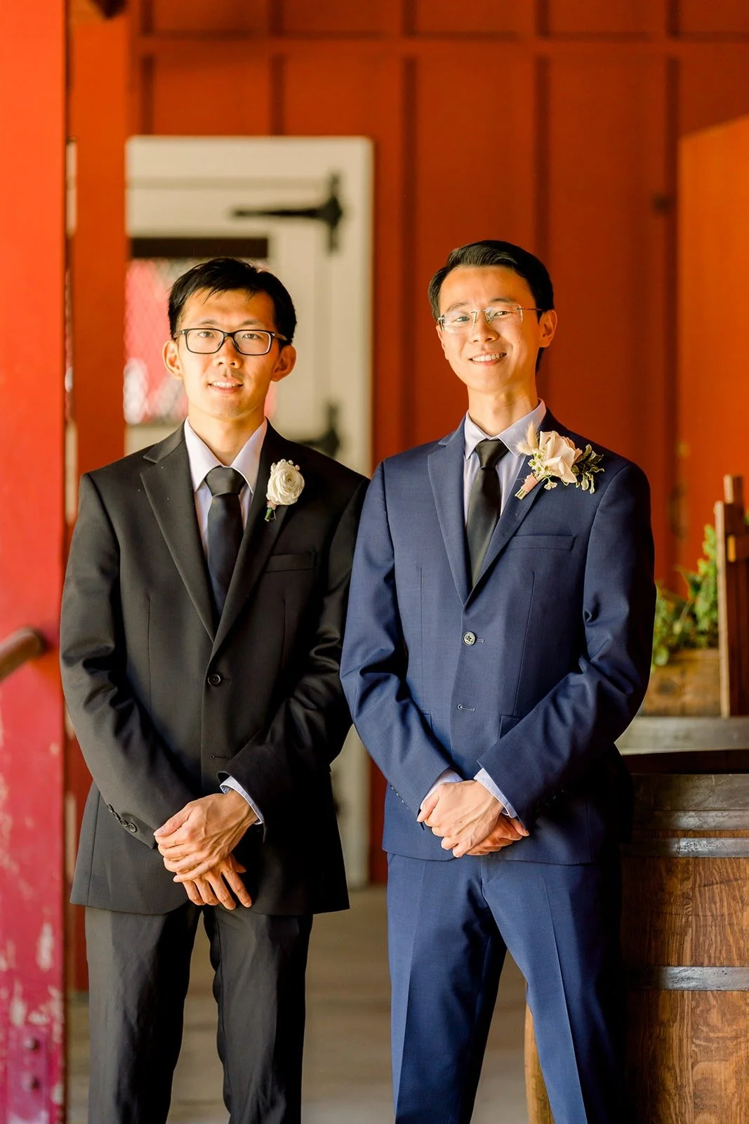 Alex and a groomsman in front of the red barn