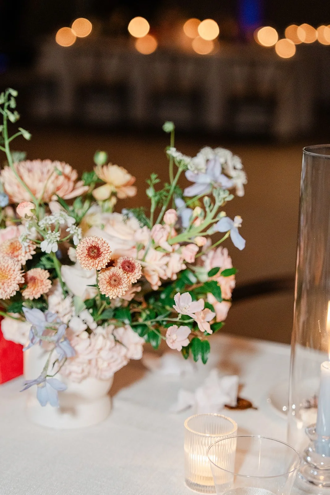 Pastel florals glowing by candlelight