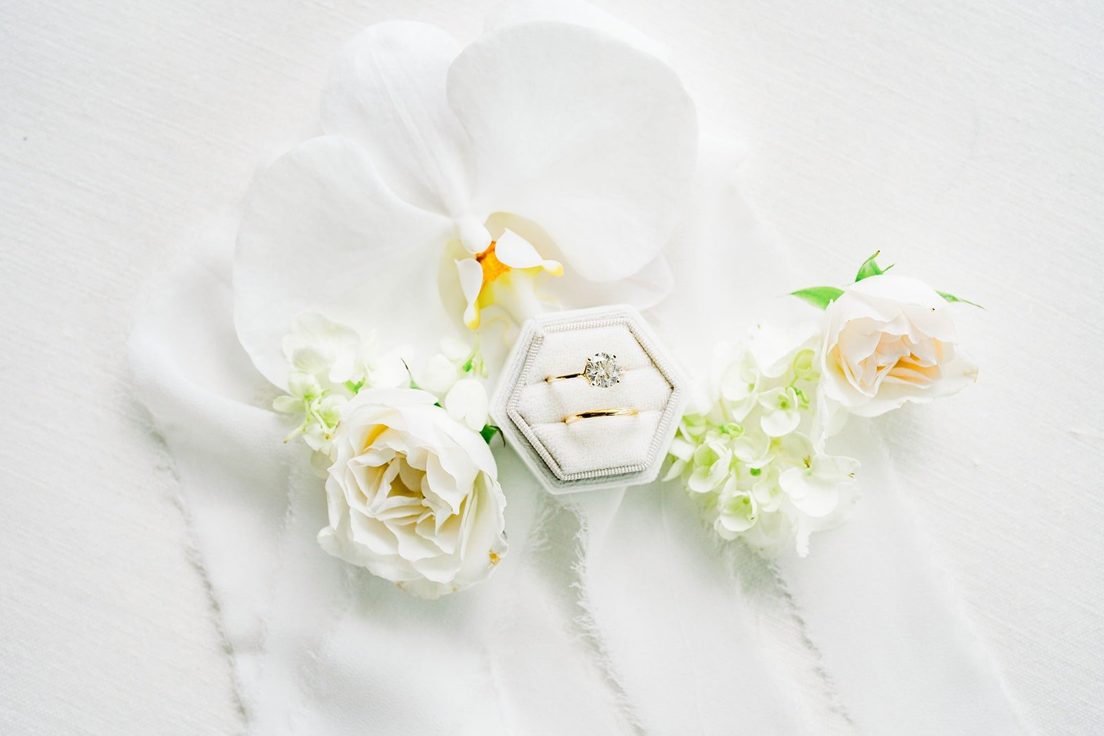 White orchids styled across the flat lay