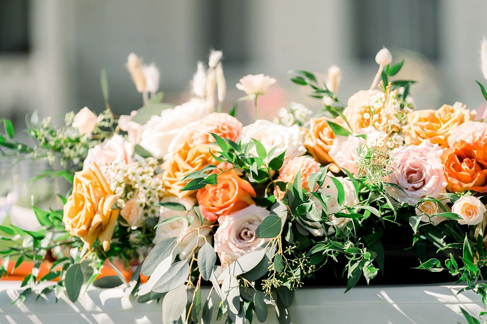 Peach, orange and white florals on the head table