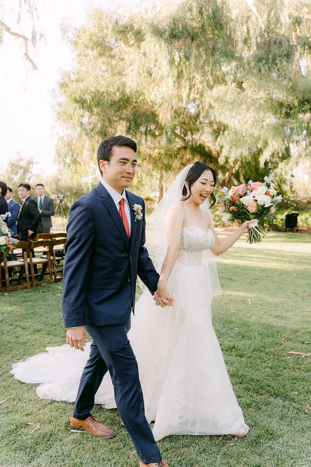 Newlyweds walking back up the aisle smiling
