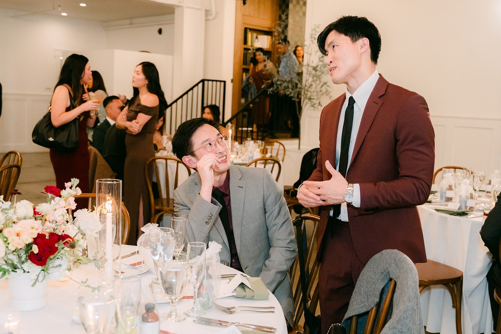 Guests laughing at their tables during the reception.
