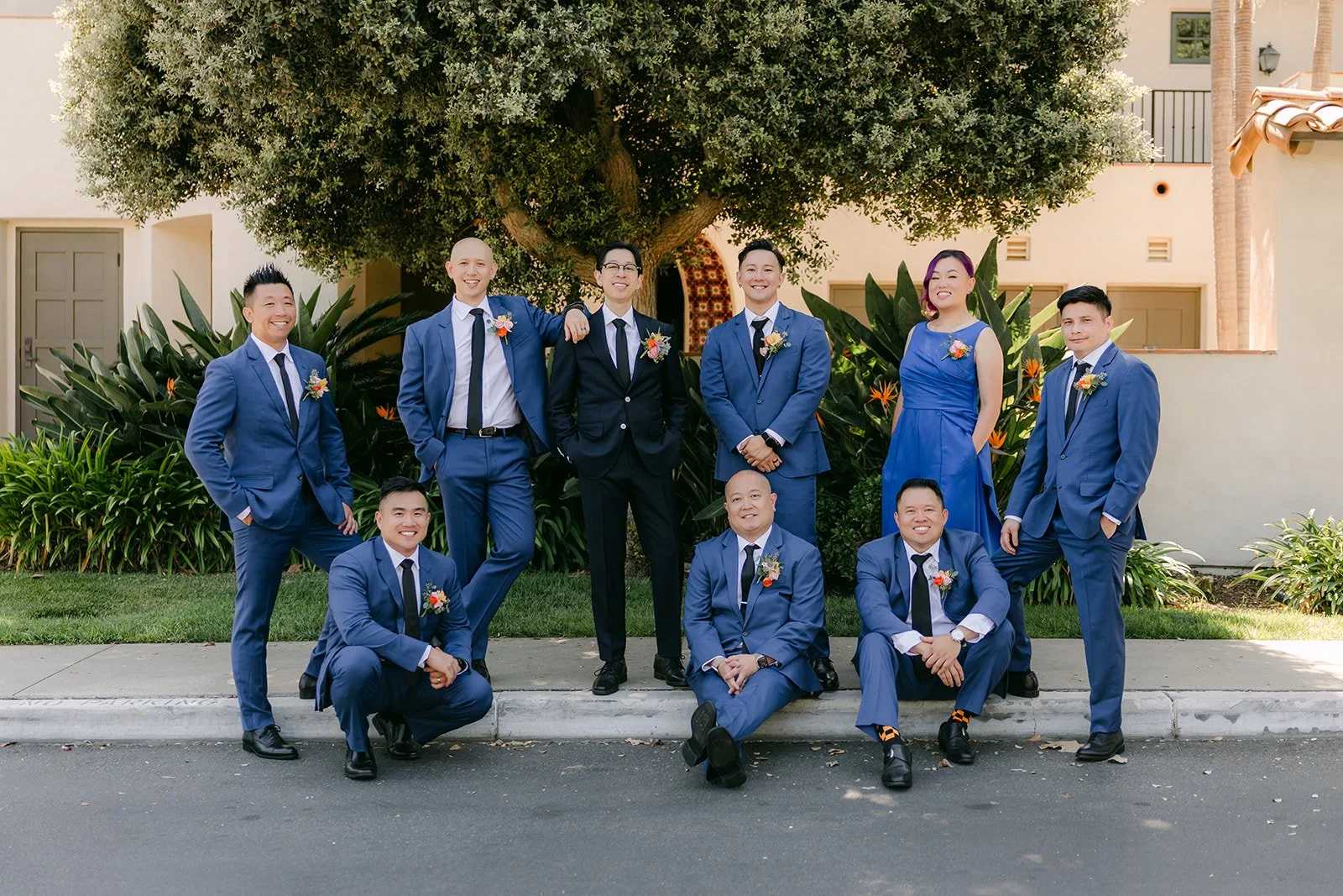 The groomsmen posing along the curb