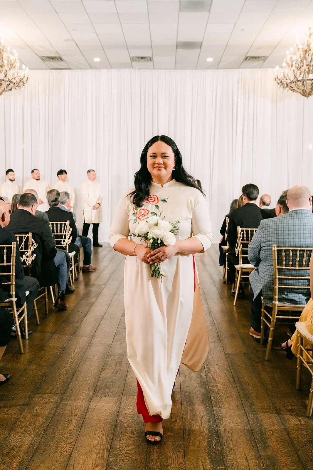 A bridesmaid walking up the aisle with a smile