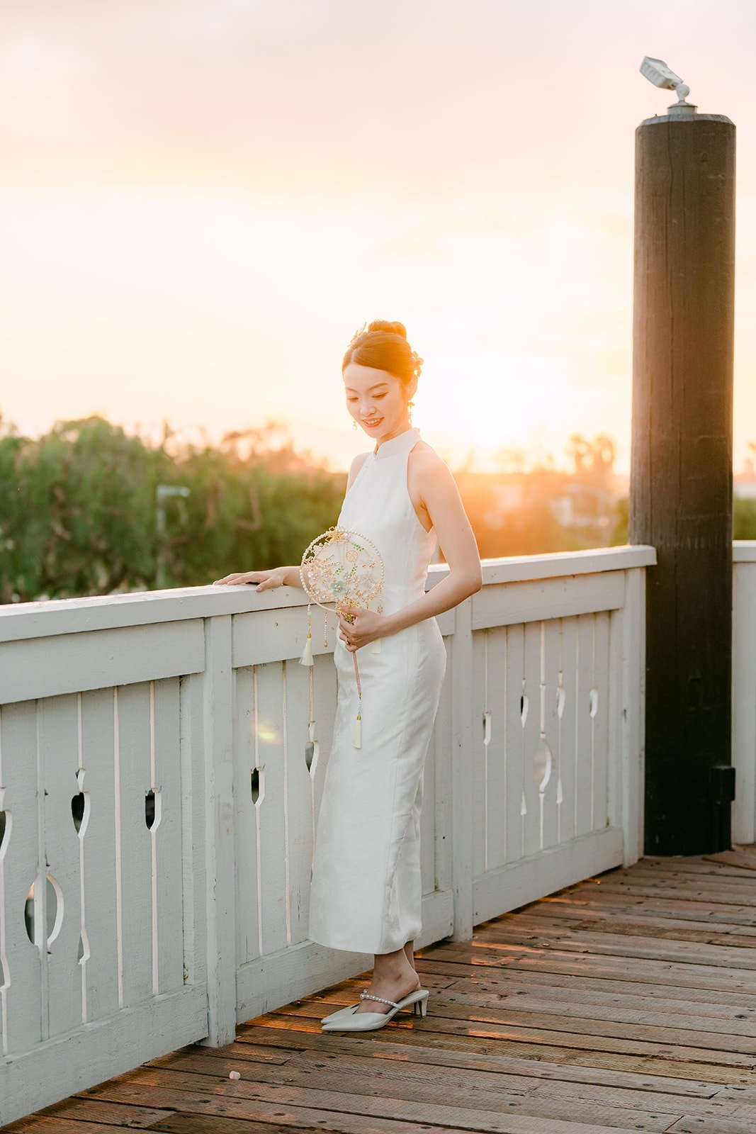 Tin by the terrace railing as the sun sets, photographed by One and Only Production