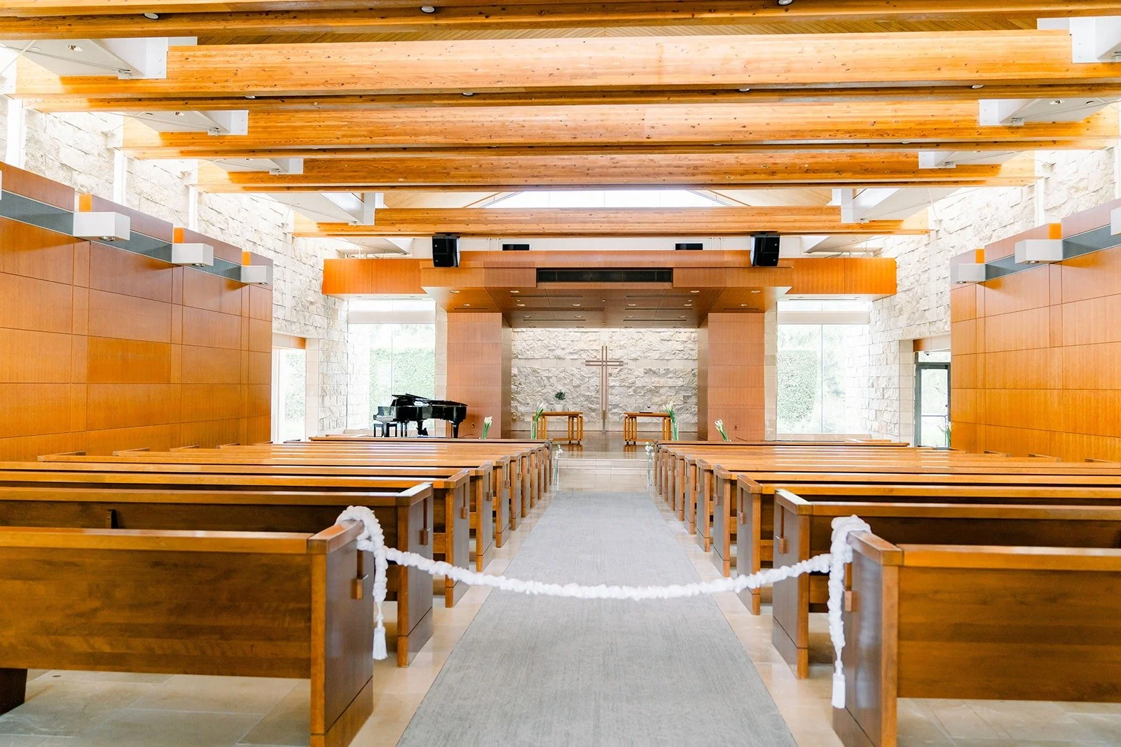 The sanctuary at Crossline Community Church with wooden pews and ceiling