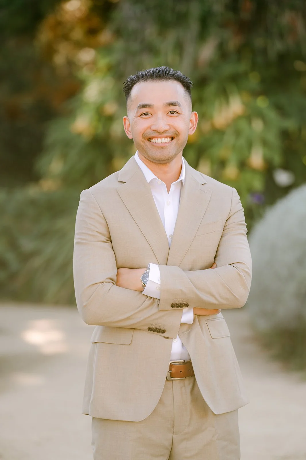 Vincent smiling in his tan suit and white shirt.