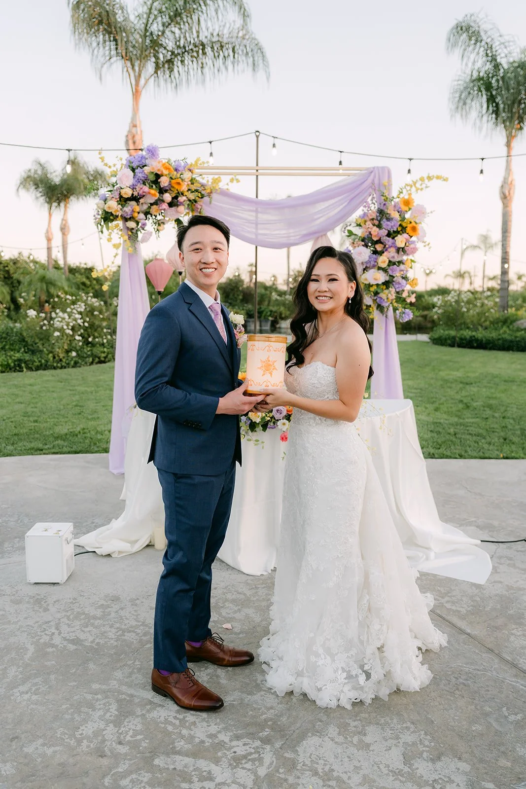 Vannie and Elijah raising their drinks at the sweetheart table, photographed by One and Only Production.