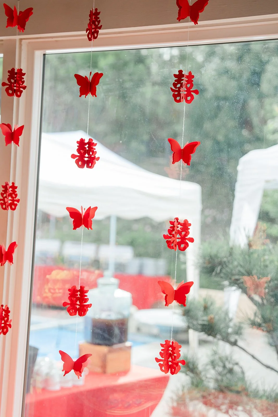 Red double happiness papercuts and butterflies hung in the windows.