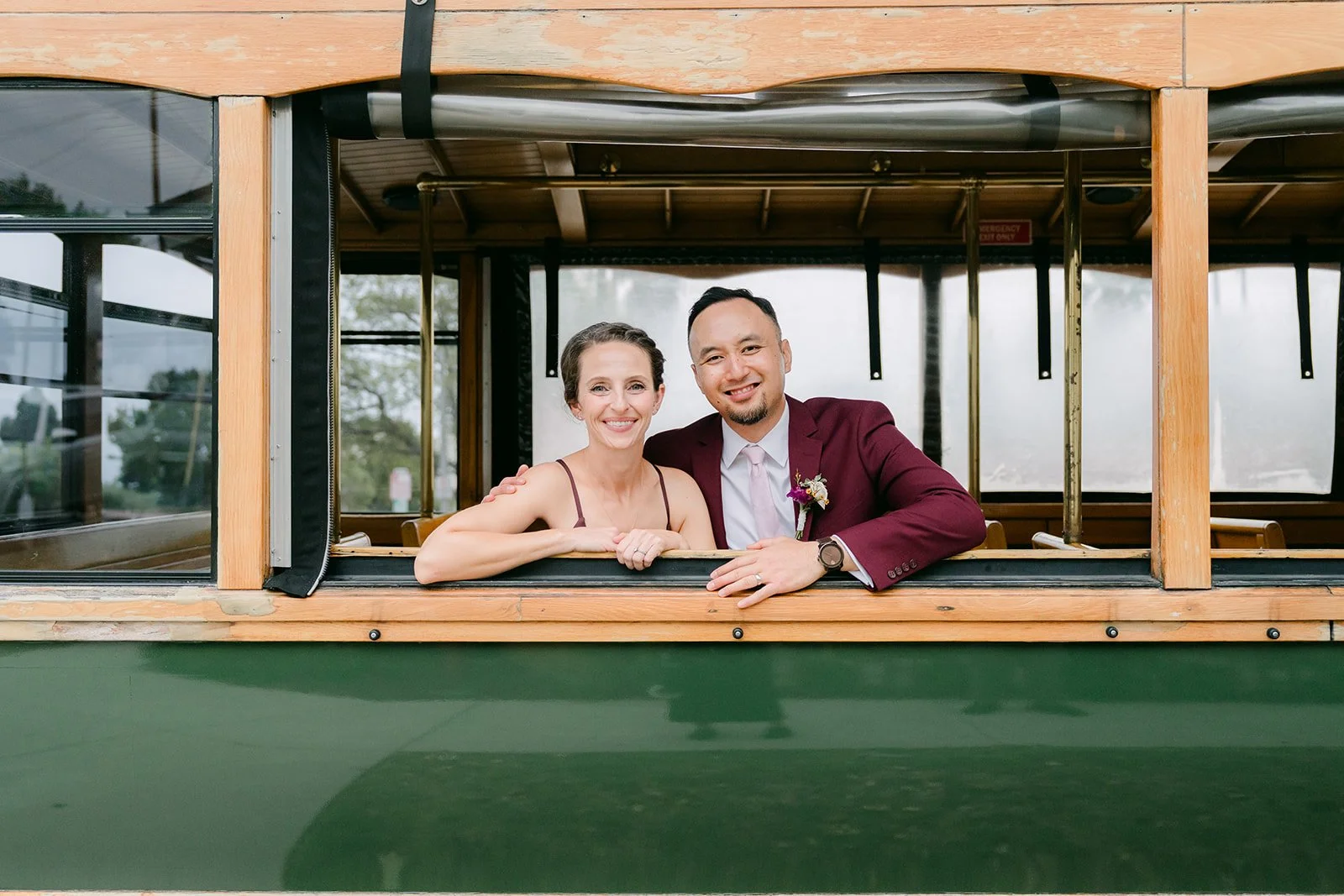 Two guests posing in the window of The Richland trolley.
