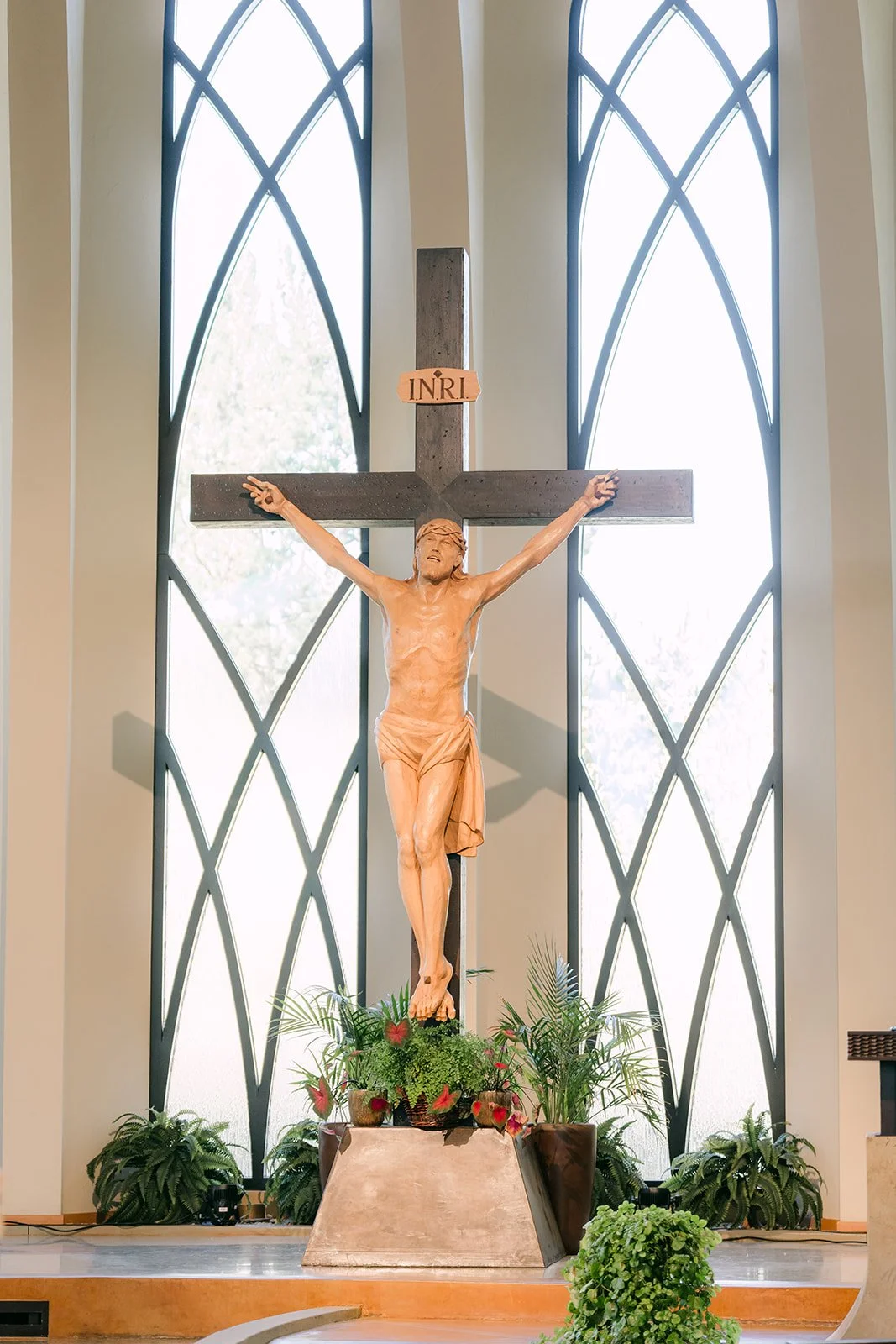 The crucifix and arched windows above the altar at St. John Fisher Church
