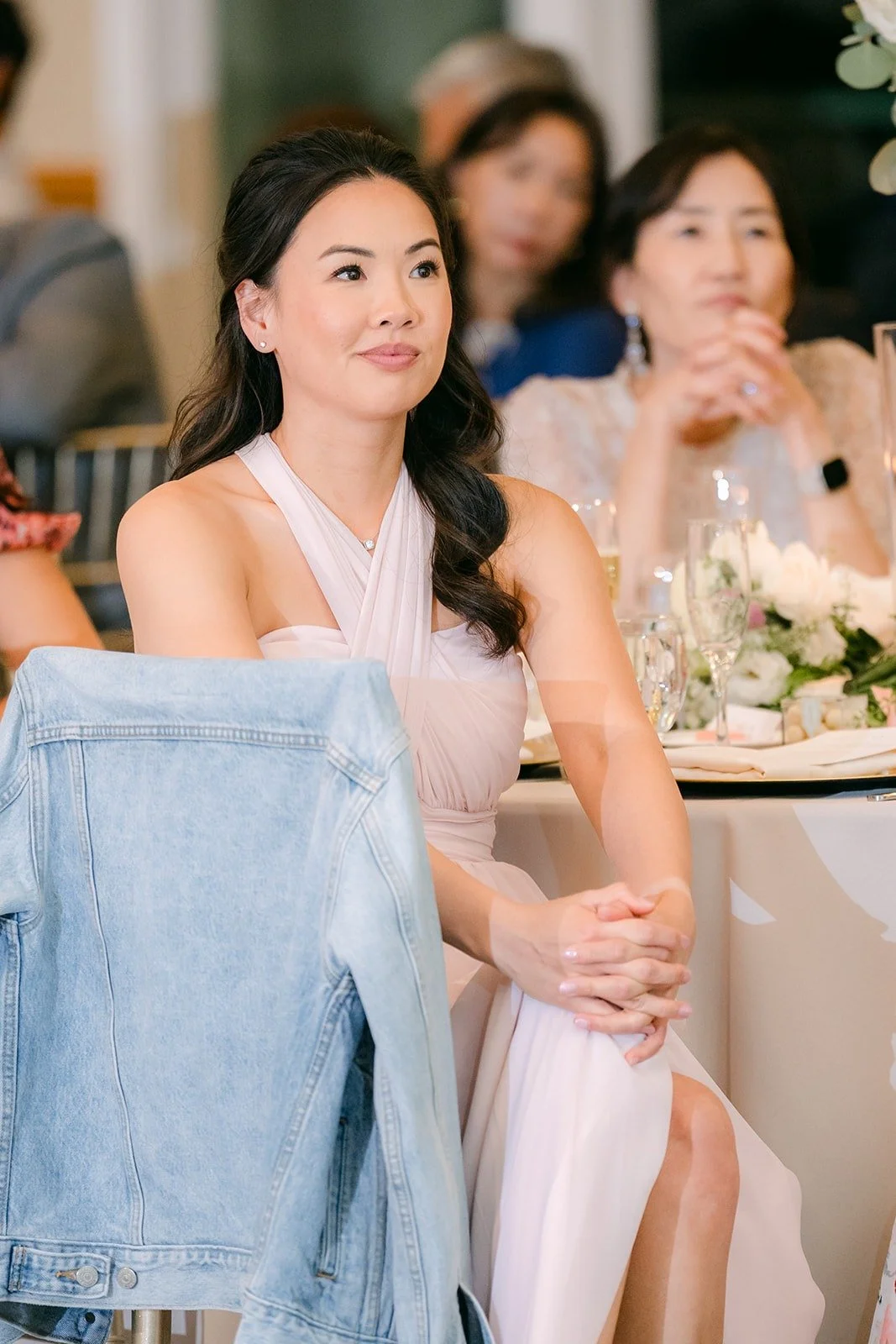 A bridesmaid laughing during a toast