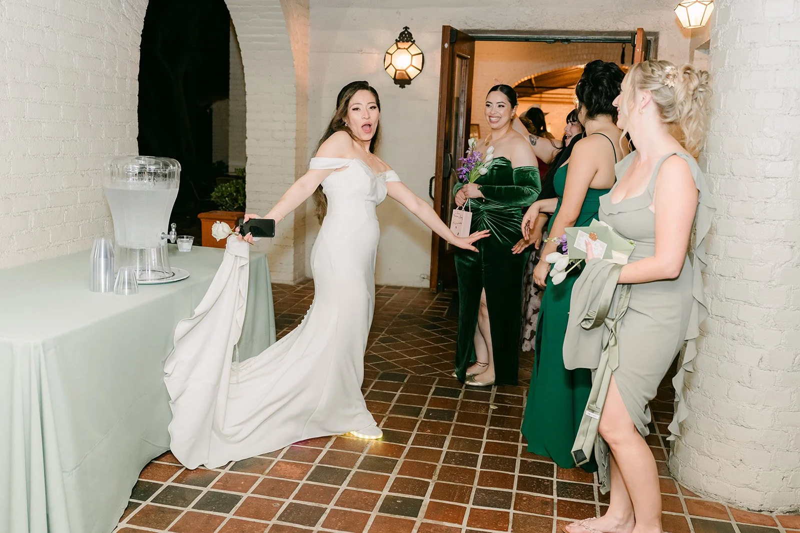 Mariana laughing with bridesmaids in the lobby before the send off