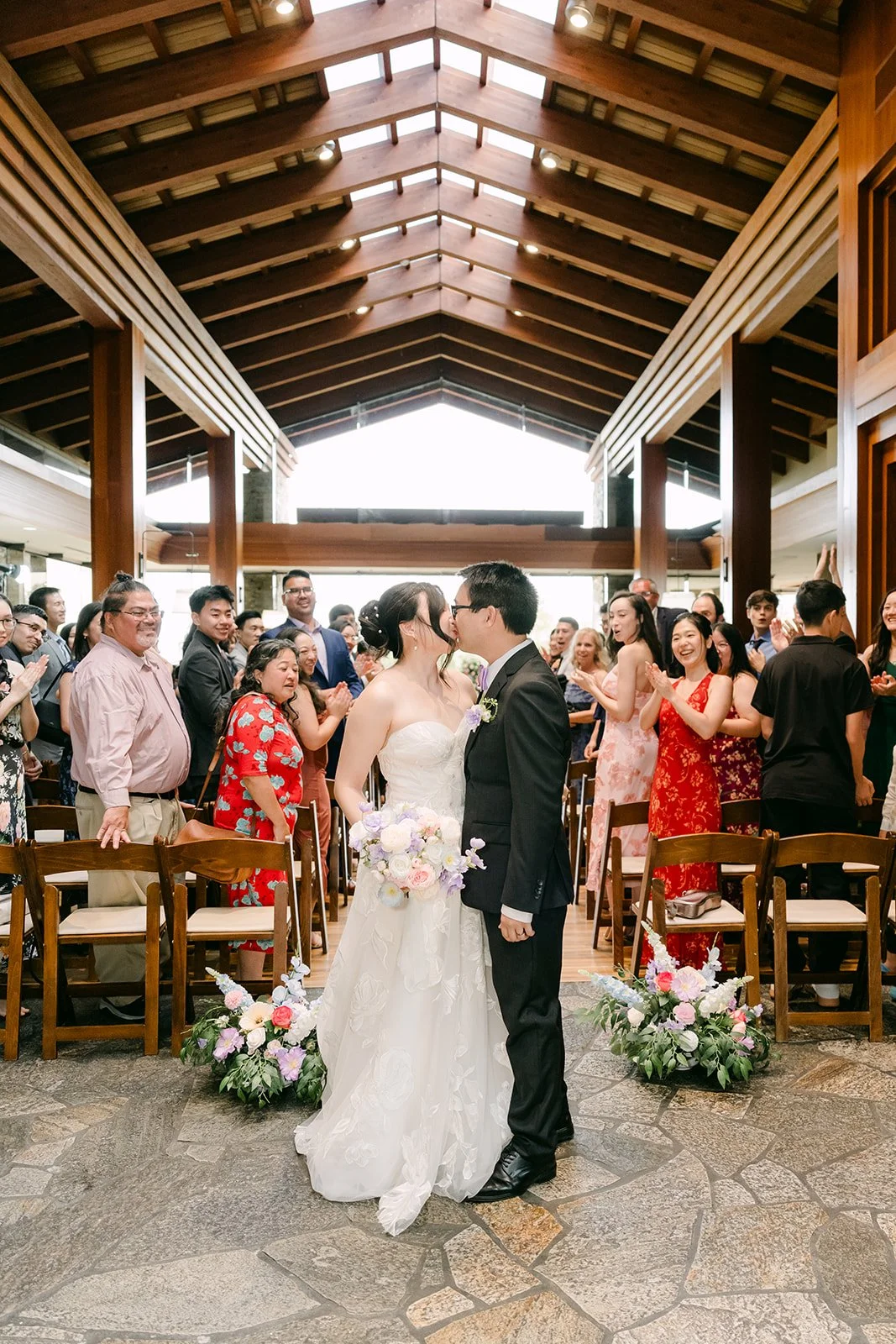 The newlyweds walking up the aisle at Dove Canyon