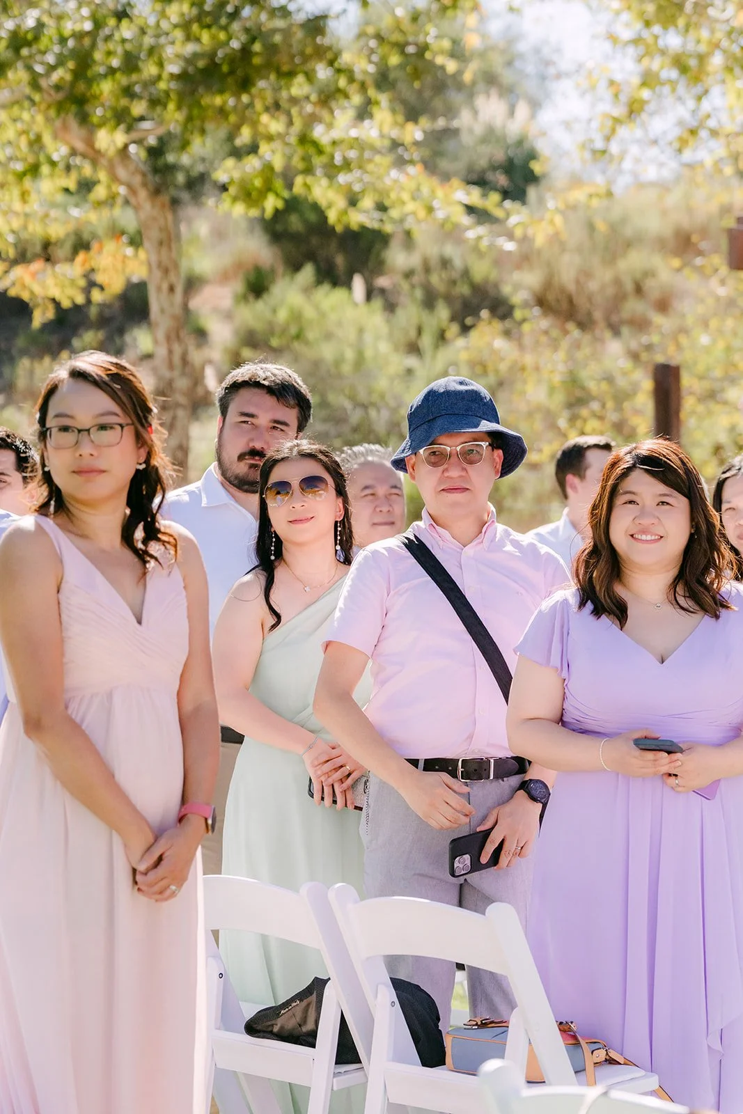 Bridesmaids in pastel dresses arriving at the ceremony.