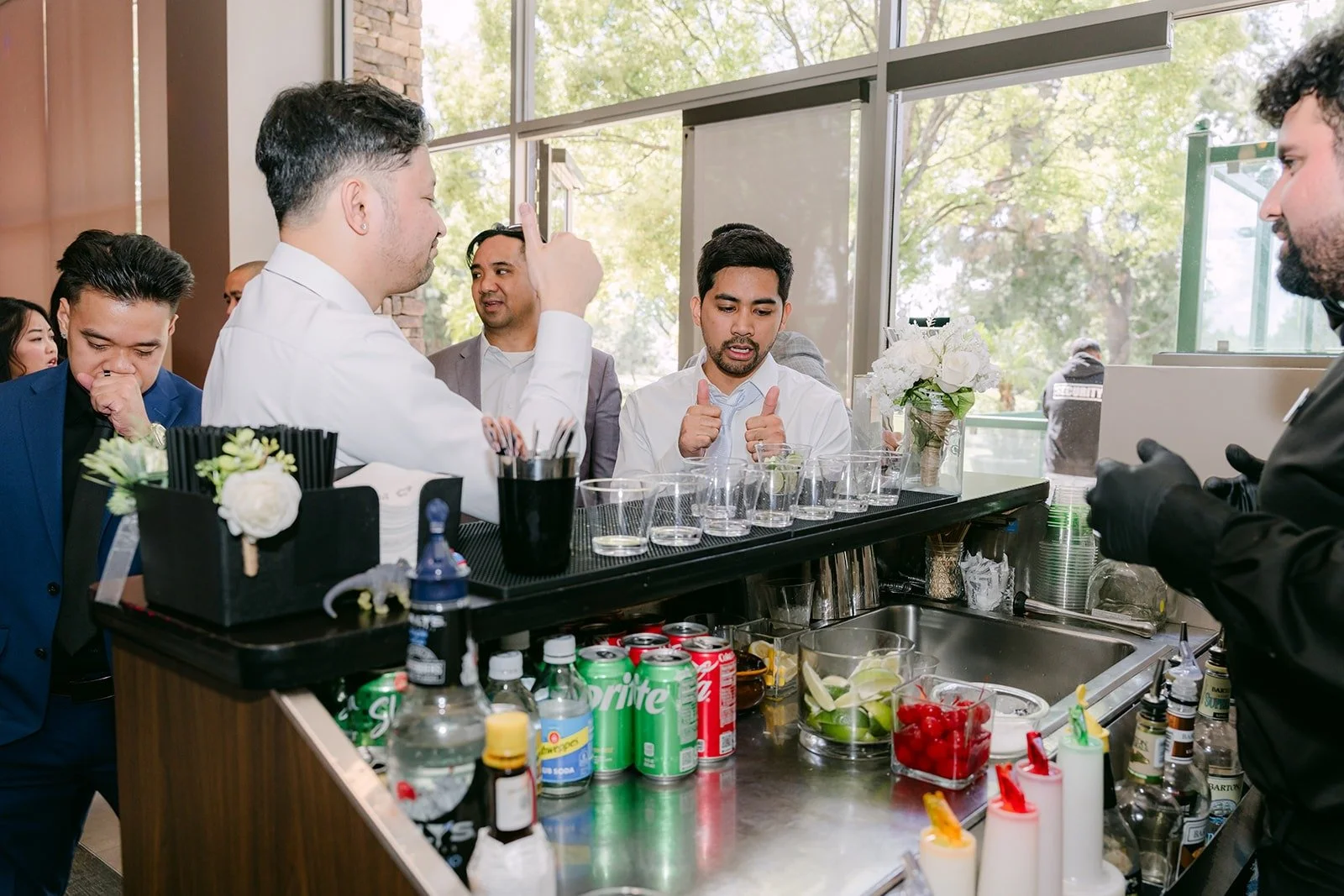 Guests ordering drinks at the bar during cocktail hour, photographed by One and Only Production